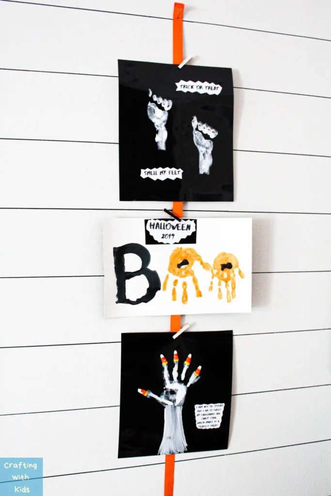 three Halloween handprint signs displayed