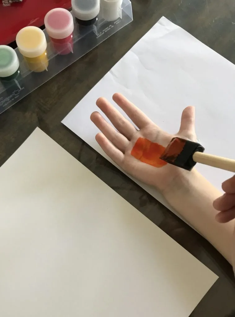 painting hand for handprint sign