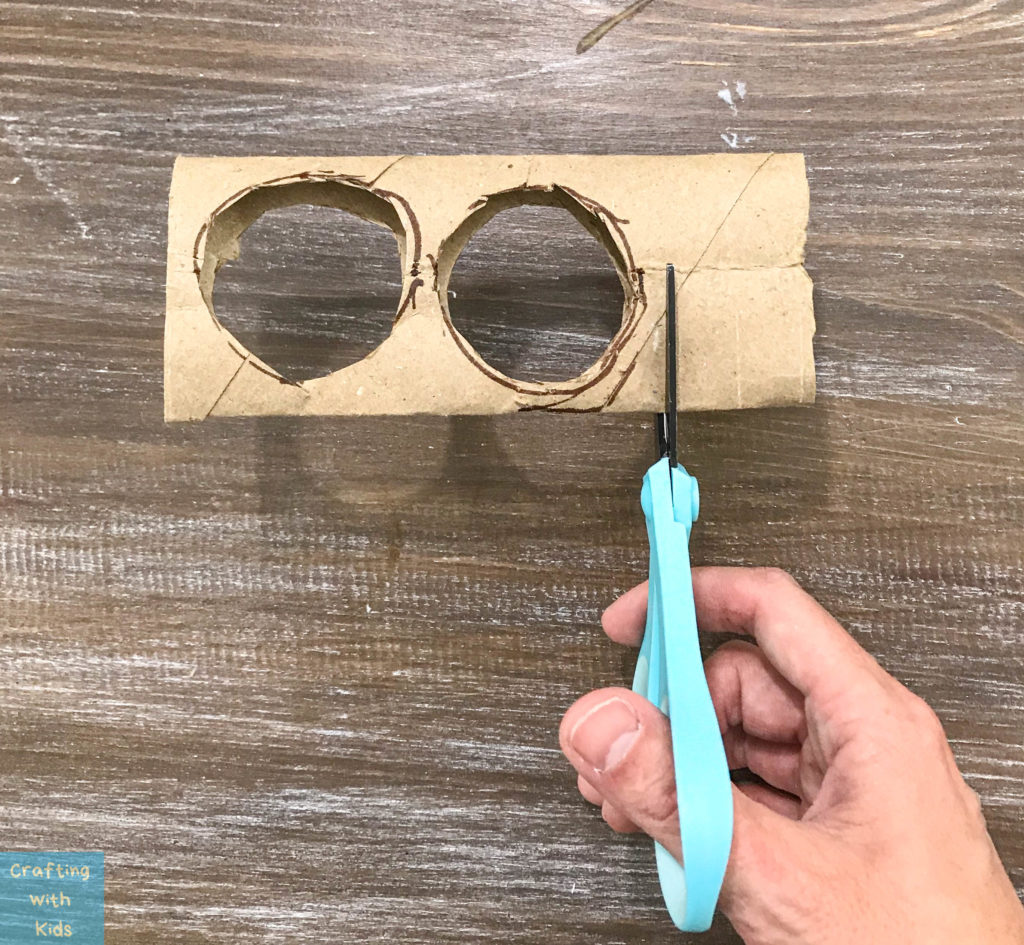 cutting the end off of the toilet paper binoculars