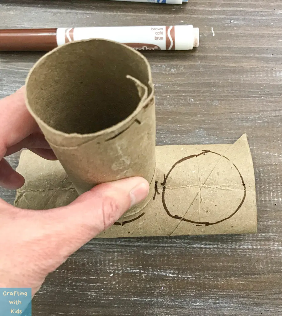 making an outline on toilet paper tube