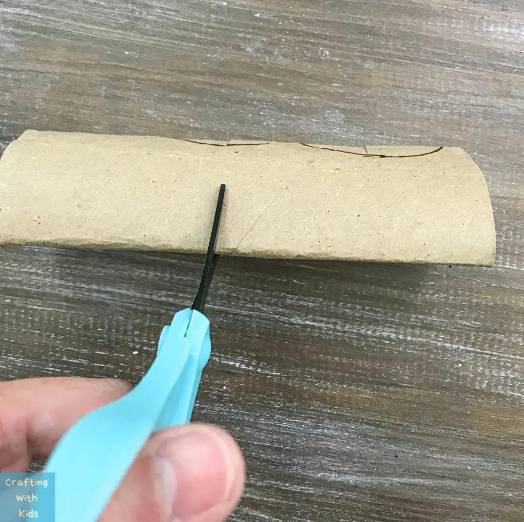 cutting two slits in toilet paper tubes