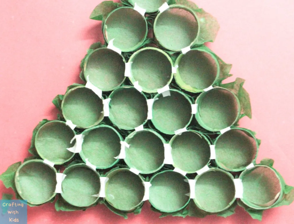 taped toilet paper tubes in the shape of a Christmas tree 