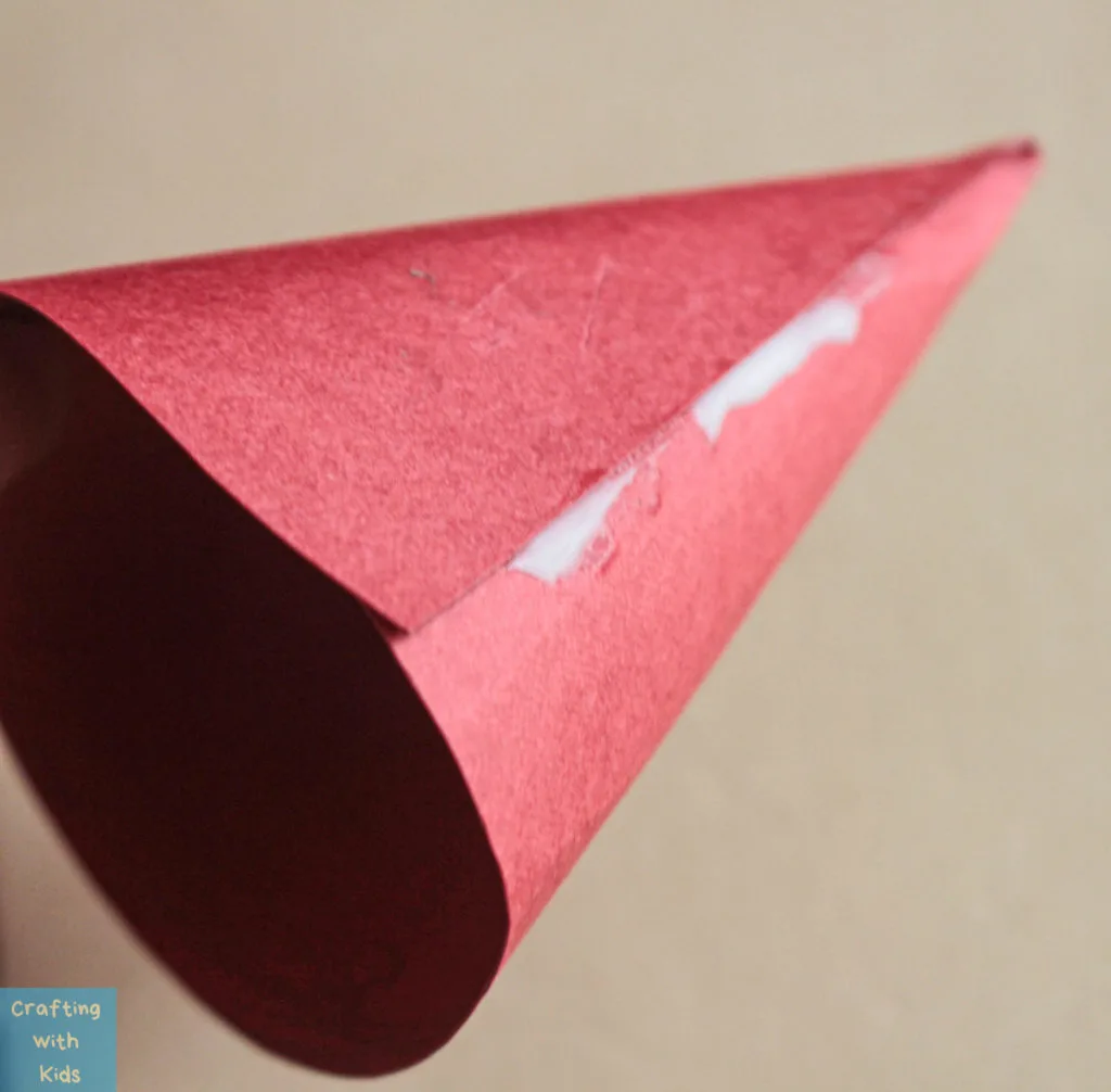 red paper rolled to look like Santas hat