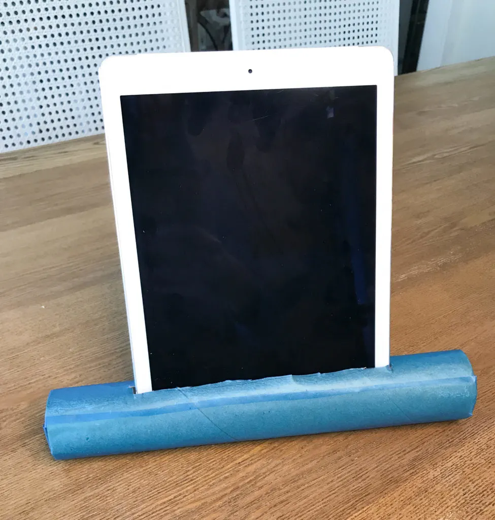 DIY vertical tablet stand from a paper towel roll 