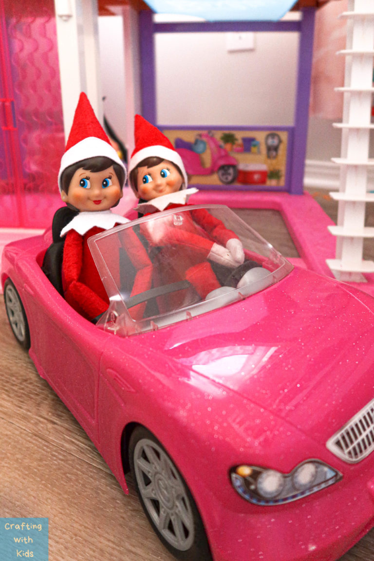two Elf on the Shelf's in barbie car