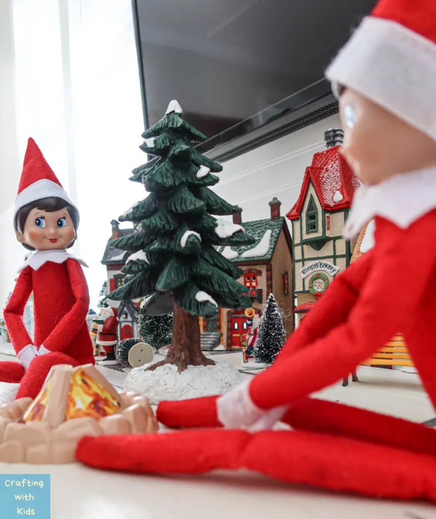 two elf on the shelf's by campfire