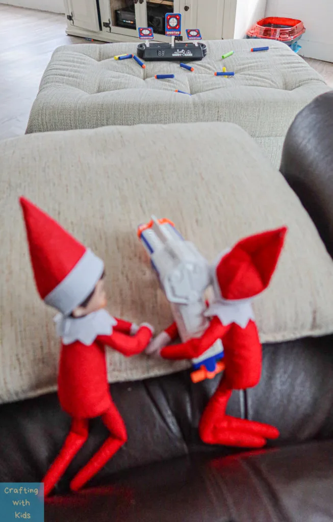 two elf on the shelf's with nerf guns 