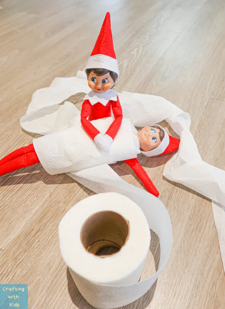 two elf on the shelf's wrapped in toilet paper