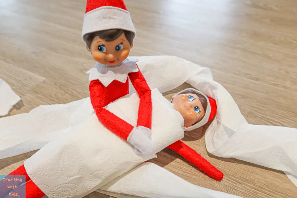 two elf on the shelf's wrapped in toilet paper