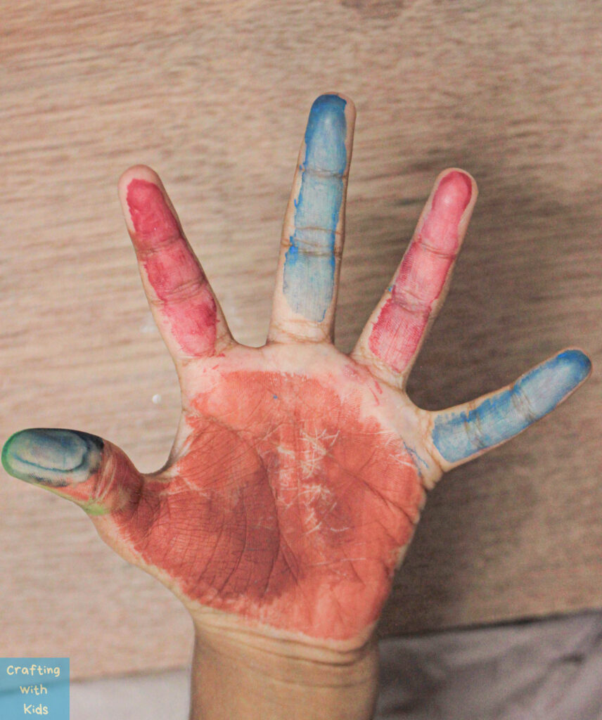 paint on child's hand for handprint Turkey craft