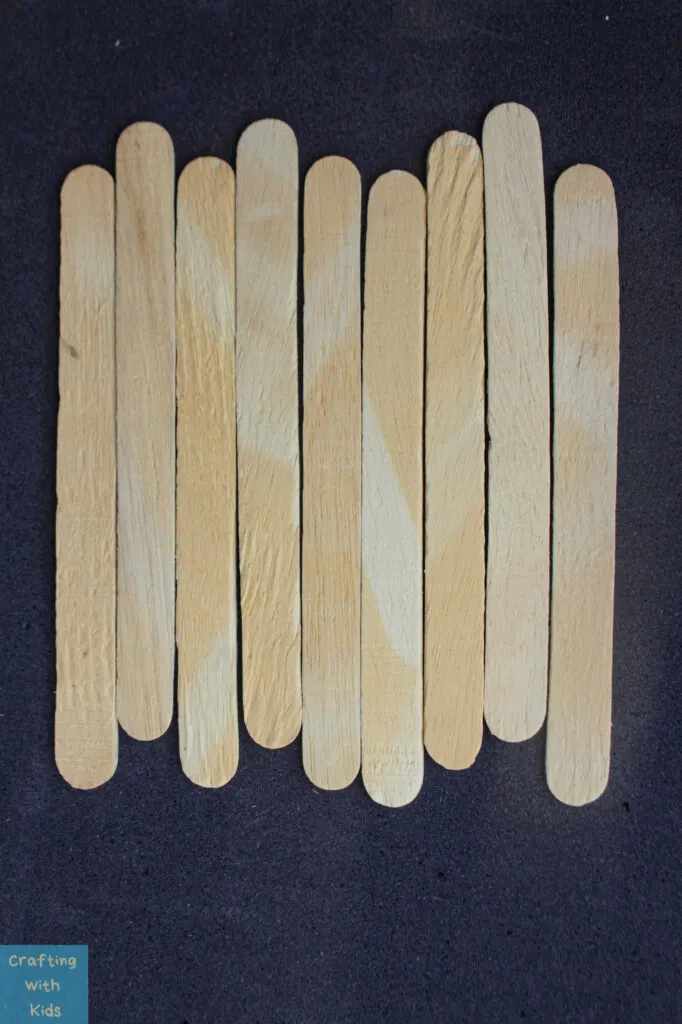 arranging popsicle sticks for pumpkin