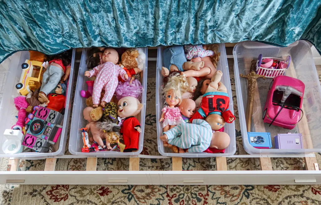 Under the bed storage idea with storage bins on a trundle