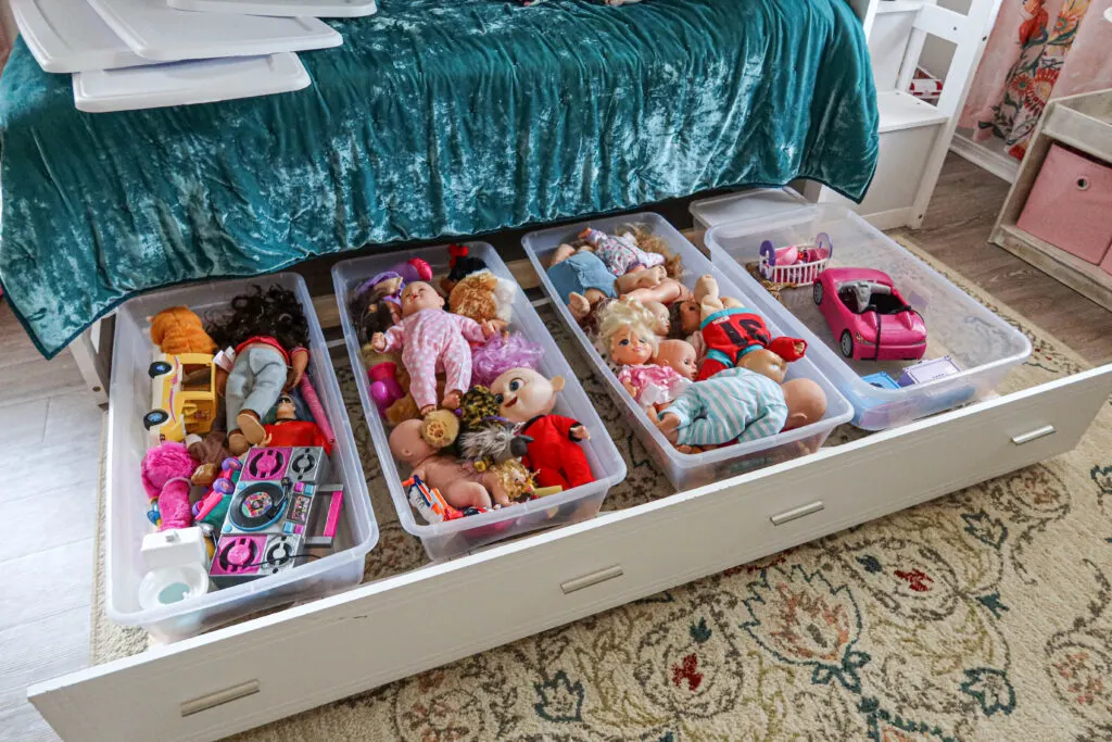 Under the bed storage idea with storage bins on a trundle