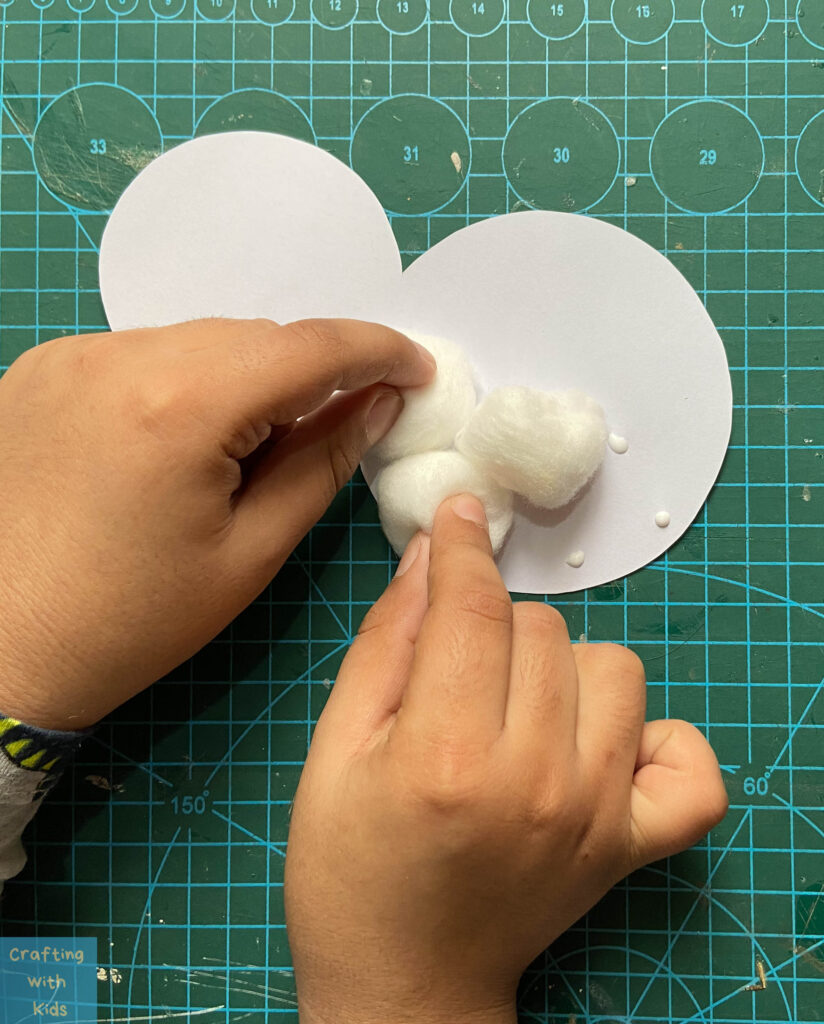 cotton balls on white paper for penguin craft