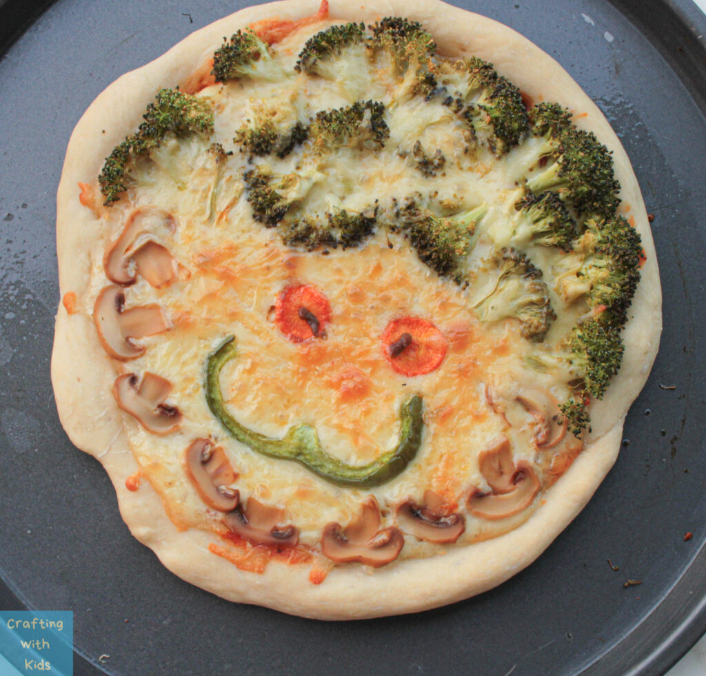 baked pizza with smiley face