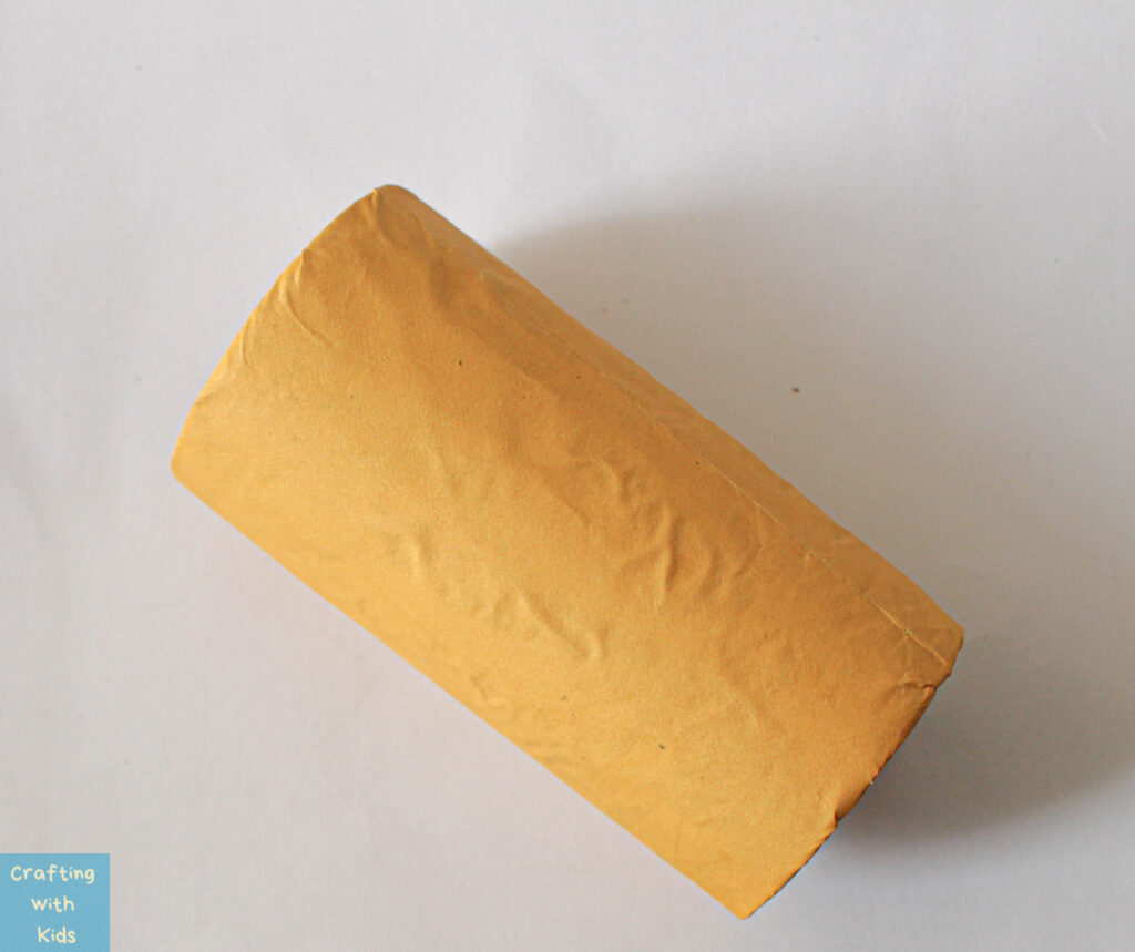 toilet paper tube with yellow construction paper