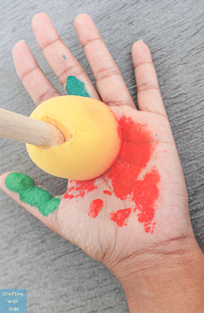 painting hand for apple handprint