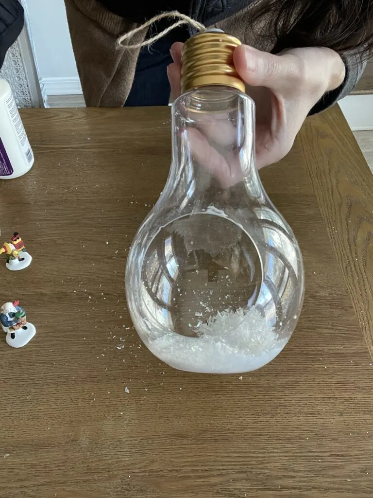 adding the filler material to the terrarium 