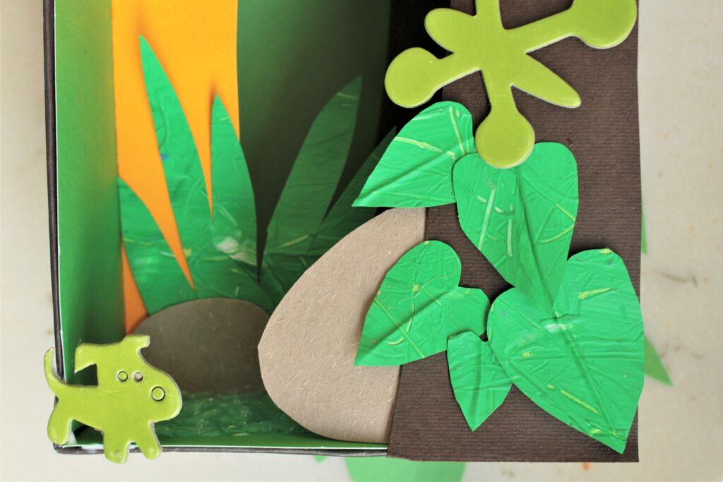 rainforest diorama with cut out animal